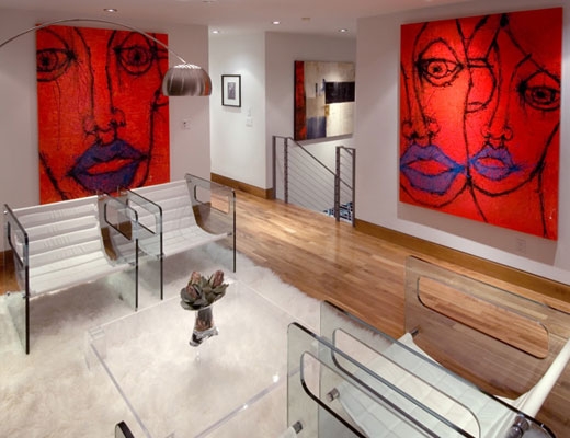 Paintings with faces on a wall in a home in
                        NYC